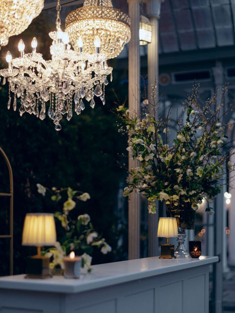Chandelier over lit candle at wedding
