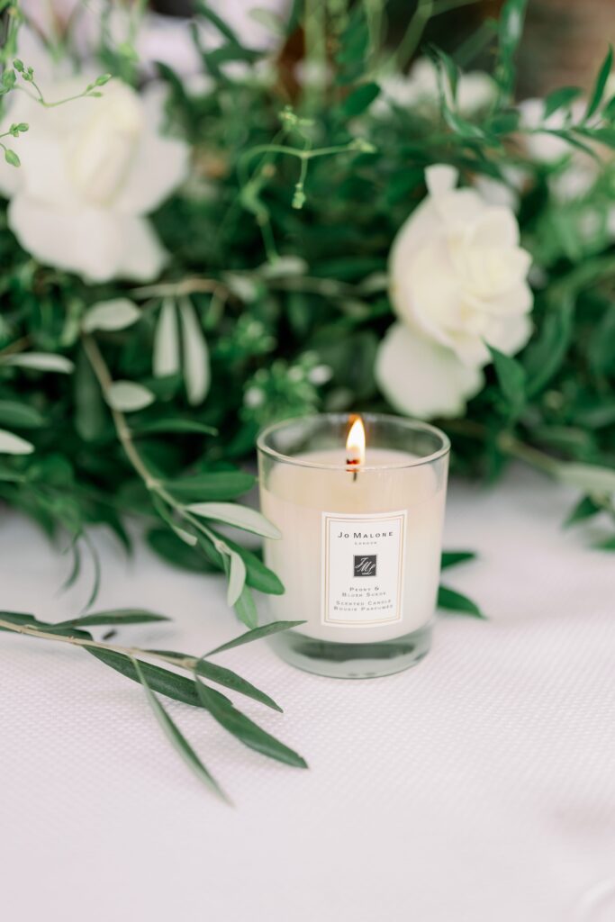 Lit Jo Malone candle on wedding breakfast table